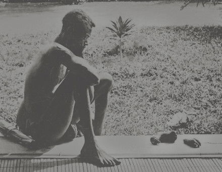 A Congolese man sits looking at a severed hand and foot. Museum of Ethnography. Public Domain.