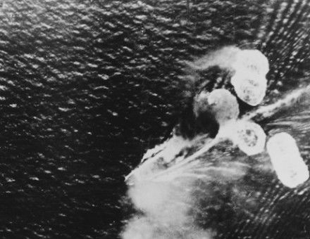 A photograph from a Japanese plane showing damage to HMS Repulse (bottom left) and HMS Prince of Wales (top right), 10 December 1941. US Naval History and Heritage Command. Public Domain.