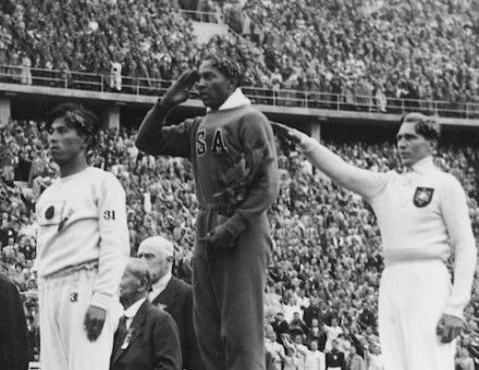 Jesse Owens, Luz Long, and Naoto Tajima recieve medals for long jump at the Berlin Olympics, 1 August 1936. Narodowe Archiwum Cyfrowe. Public Domain.