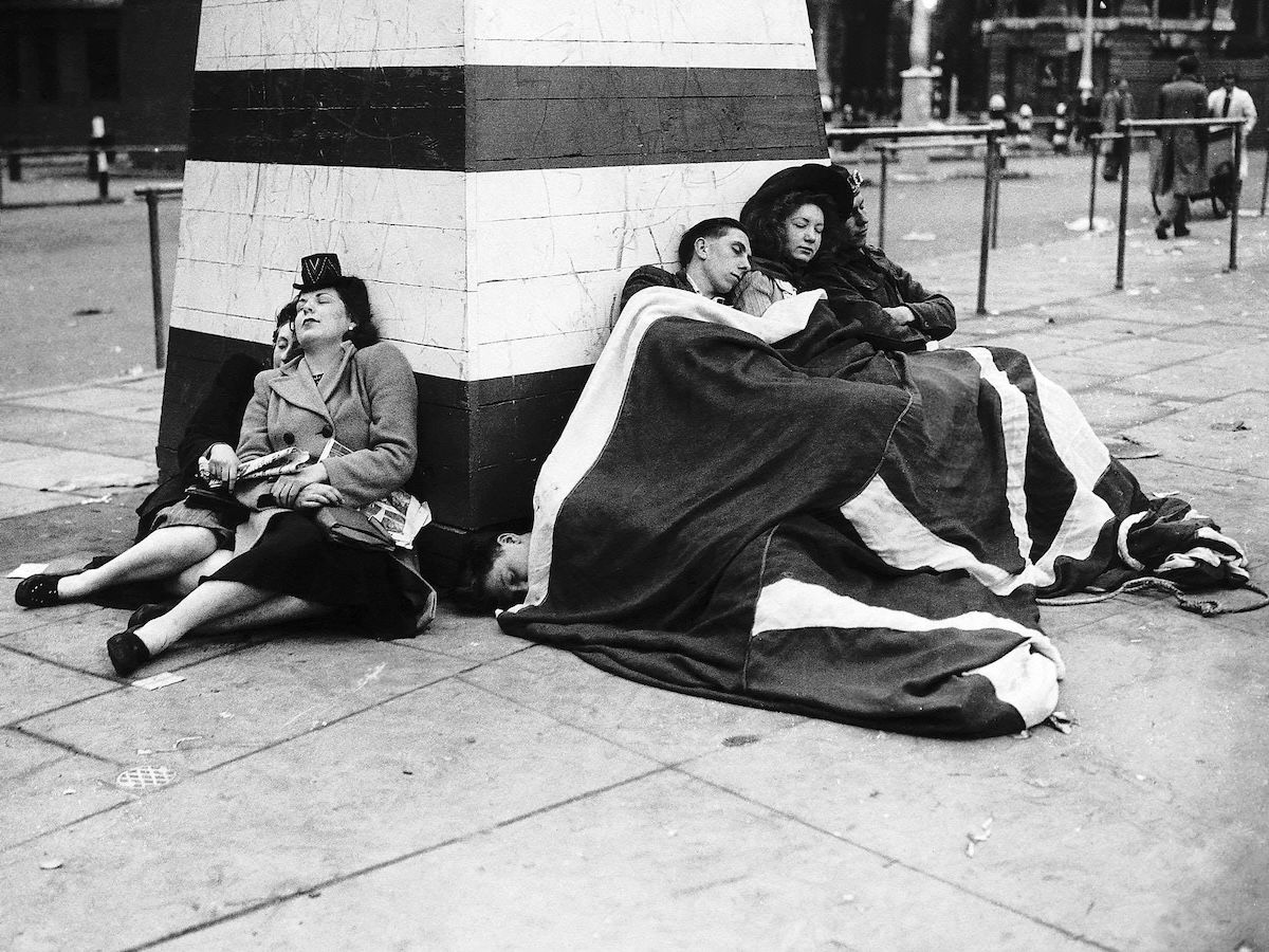 Londoners sleep through the early hours of the morning after a night of celebrations, 8 May 1945. Mirrorpix.